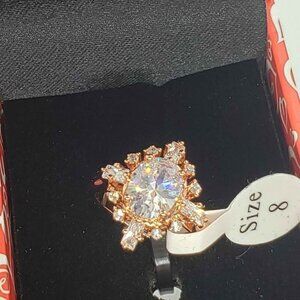 18k rose gold plated ring with cubic zirconia stones and one gemstone